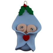 Ornament with twin infant heads poking out of a blue baby blanket.