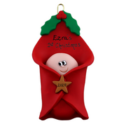 Ornament with an infant head poking out of a red baby blanket, personalized with names.