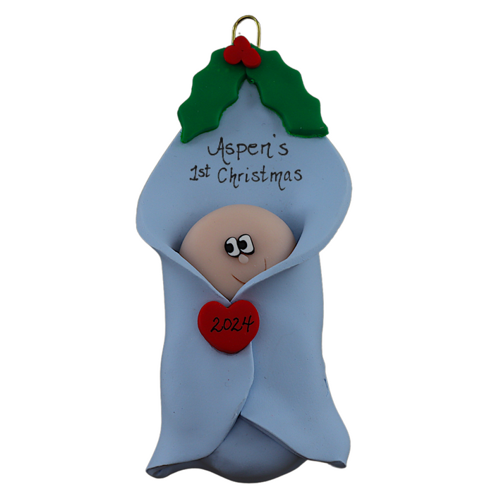 Ornament with infant head poking out of a blue baby blanket, personalized with name.