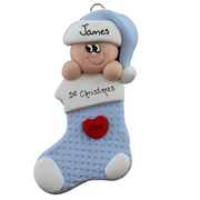 Ornament with infant head in a blue hat poking out of a blue stocking, personalized with name.