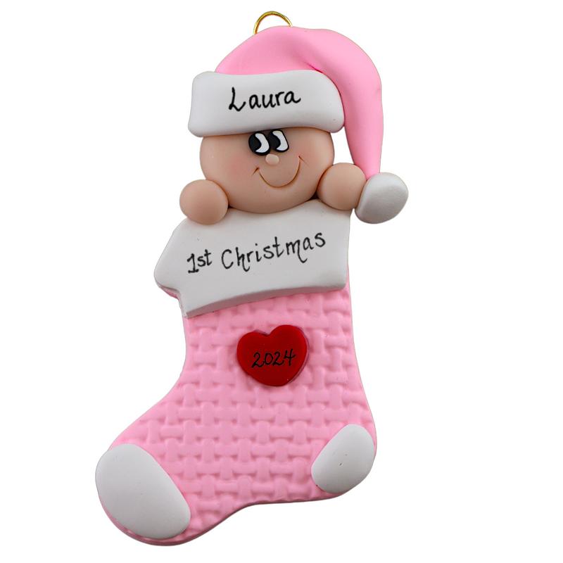 Ornament with infant head in a pink hat poking out of a pink stocking, personalized with name.