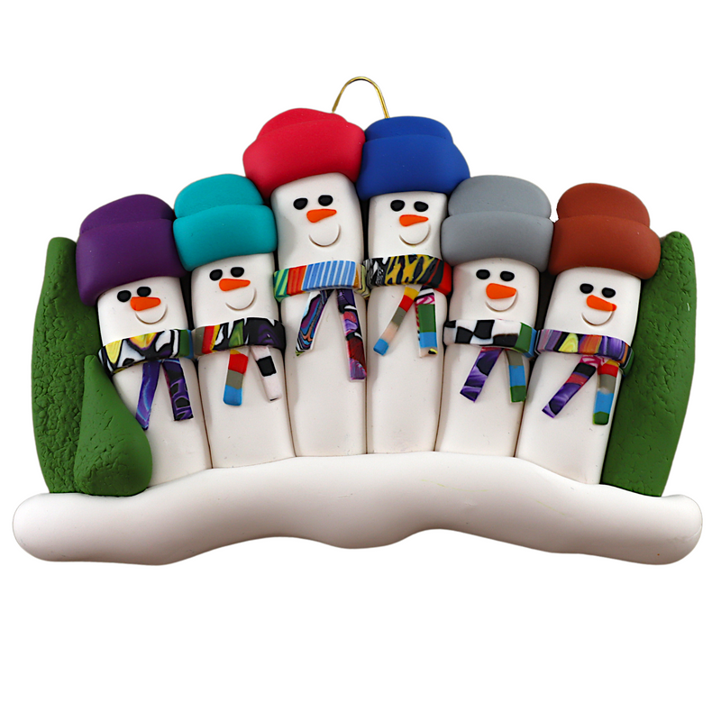 Family ornament with 6 snowmen in colourful scarves and hats, hemmed by Christmas trees.