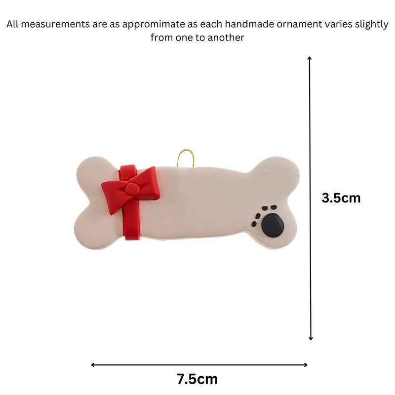Ornament of dog bone with ribbon and paw print, graphed to show size (7.5x3.5cm).