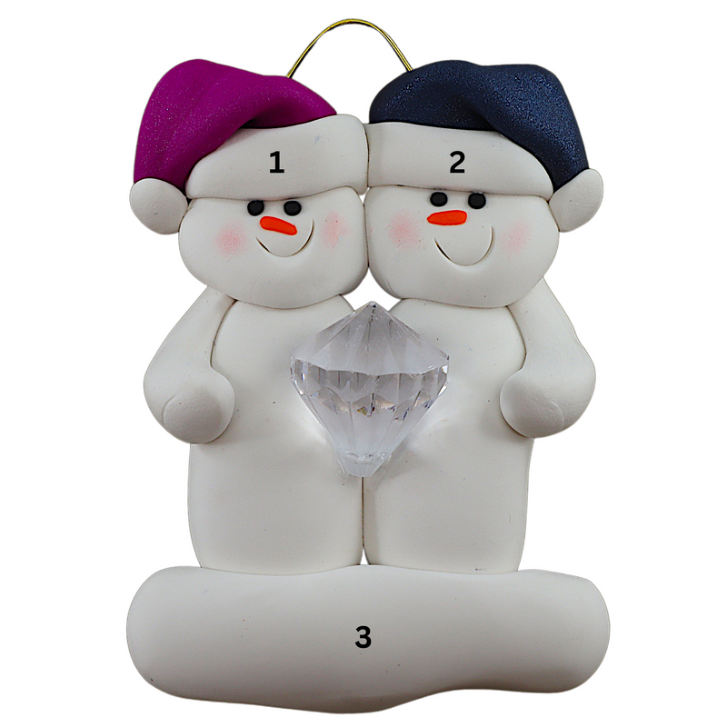 A couple’s ornament of two white snowmen holding a plastic diamond, numbered 1-3 for personalization.
