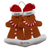 Family ornament with 2 brown gingerbread figures in red Christmas hats, personalized with names.
