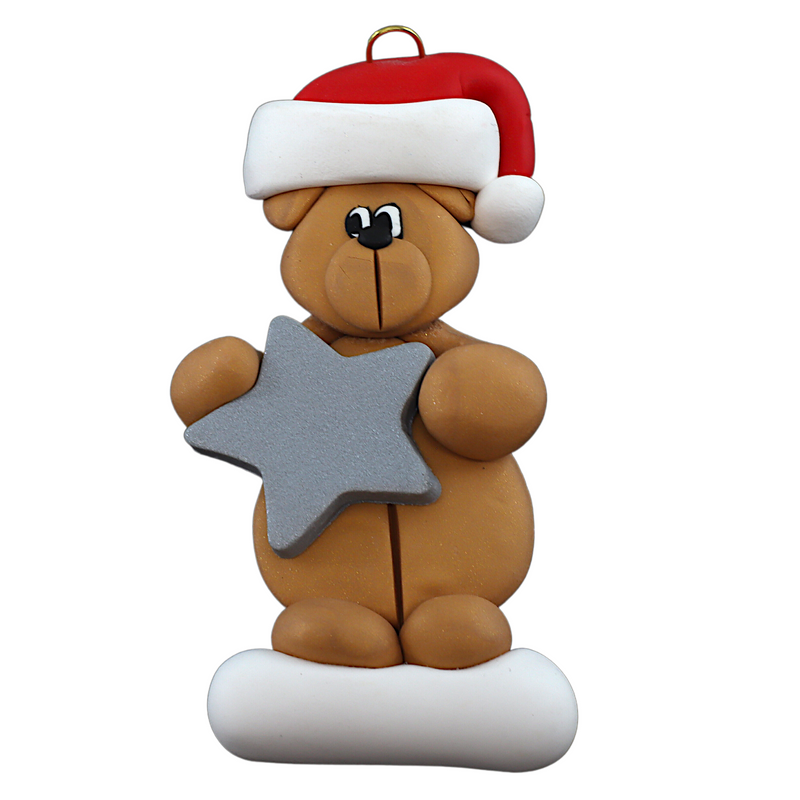 Tan bear in red festive hat holding silver star ornament.