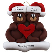A couple’s ornament of two brown bears holding a red heart together, personalized with names.