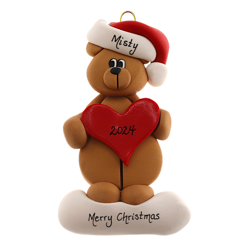Tan bear in red festive hat holding red heart ornament, personalized with name.