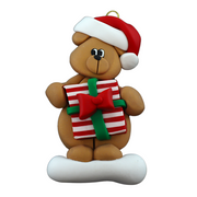 Tan bear in red festive hat holding colourful present ornament.