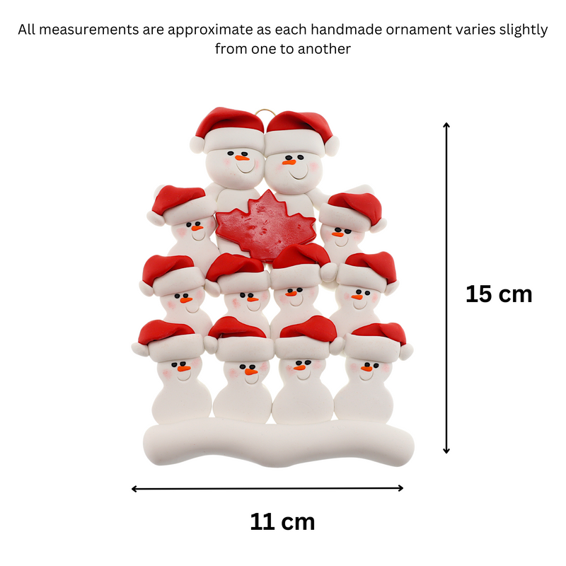 Family ornament with 12 white snowmen in red hats, gathered around a red maple leaf, graphed to show size (11x15cm).