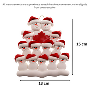 Family ornament with 13 white snowmen in red hats, gathered around a red maple leaf, graphed to show size (13x15cm).