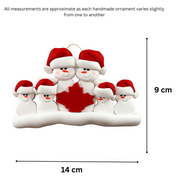 Family ornament with 6 white snowmen in red hats, gathered around a red maple leaf, graphed to show size (14x9cm).