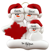 Family ornament with 3 white snowmen in red hats, gathered around a red maple leaf, personalized with names.