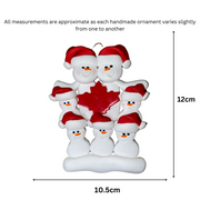 Family ornament with 7 white snowmen in red hats, gathered around a red maple leaf, graphed to show size (10.5x12cm).