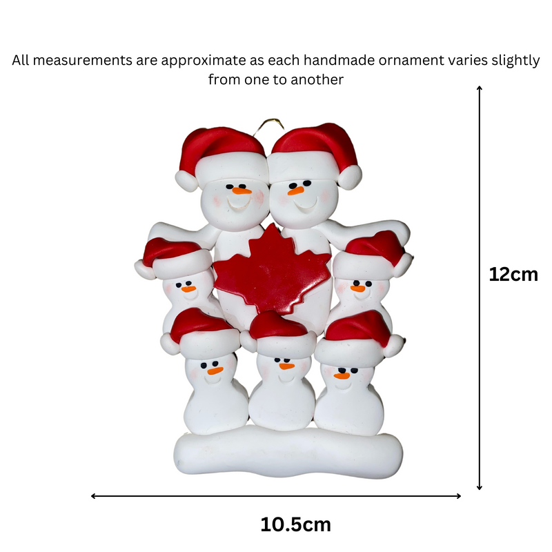 Family ornament with 7 white snowmen in red hats, gathered around a red maple leaf, graphed to show size (10.5x12cm).