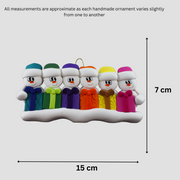 Family ornament with 6 white snowmen in colourful hats holding matching presents, graphed to show size (15x7cm).