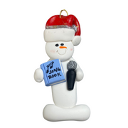 Ornament of white snowman in red hat holding a microphone and blue music book.