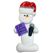 Ornament of white snowman in red hat holding a microphone and purple music book.