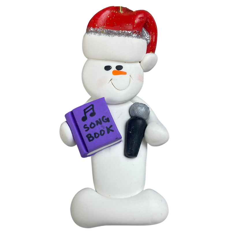 Ornament of white snowman in red hat holding a microphone and purple music book.