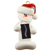 Ornament of white snowman in red hat holding black and white x-ray of a spine.