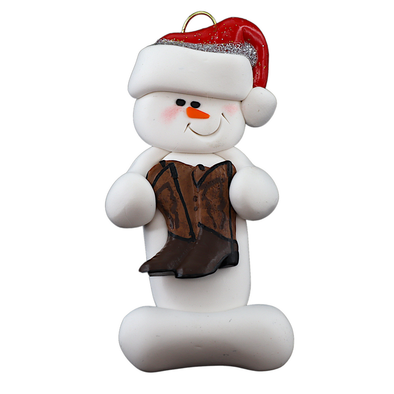 Ornament of white snowman in red hat holding cowboy boots.