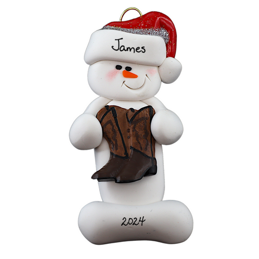 Ornament of white snowman in red hat holding cowboy boots, personalized with name.
