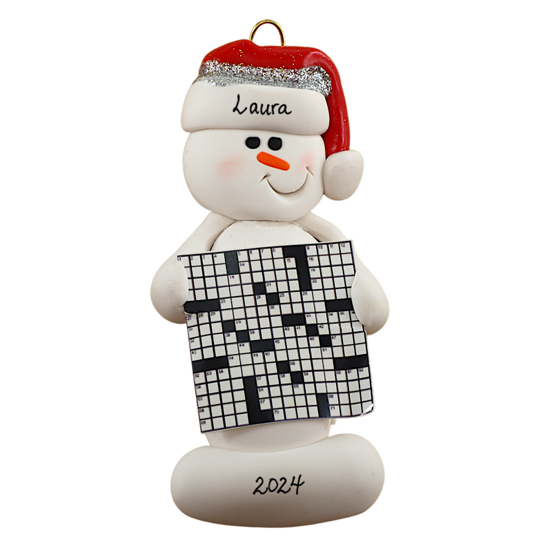 Ornament of white snowman in red hat holding large crossword puzzle, personalized with name.
