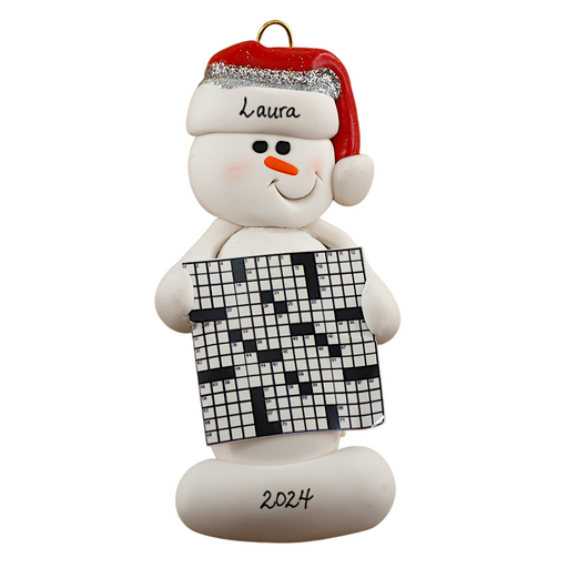 Ornament of white snowman in red hat holding large crossword puzzle, personalized with name.
