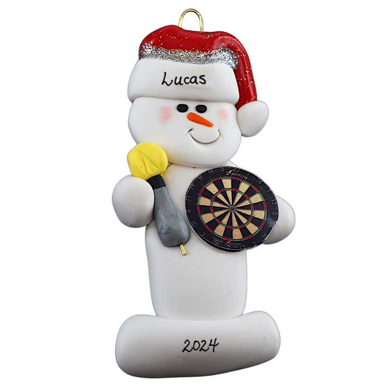 Ornament of white snowman in red hat holding dart board and one dart, personalized with name.