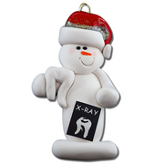 Ornament of white snowman in red hat holding dental x-ray and white tooth.