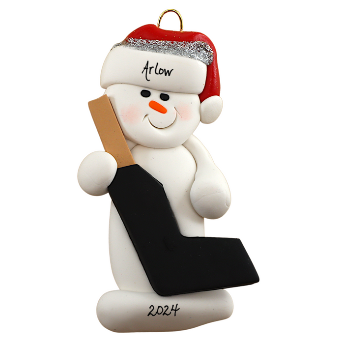 Ornament of white snowman in red hat holding a goalie stick, personalized with name.