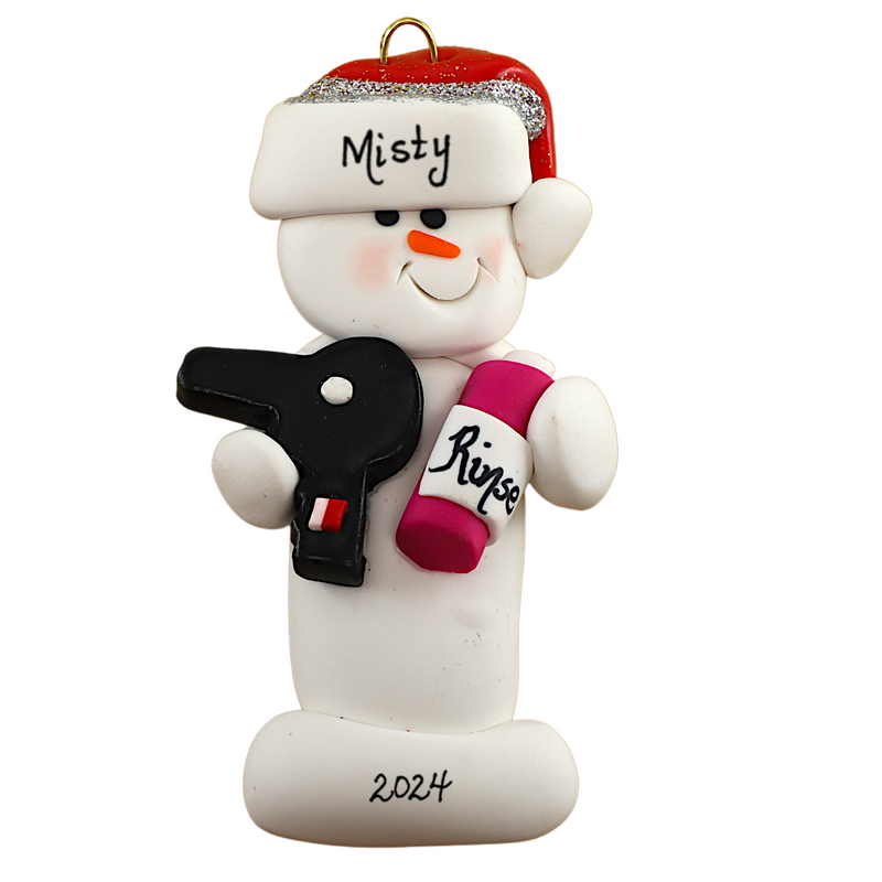 Ornament of white snowman in red hat holding a hairdryer and bottle of hair product, personalized with name.