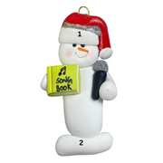 Ornament of white snowman in red hat holding a microphone and green music book, numbered 1-2 for personalization.
