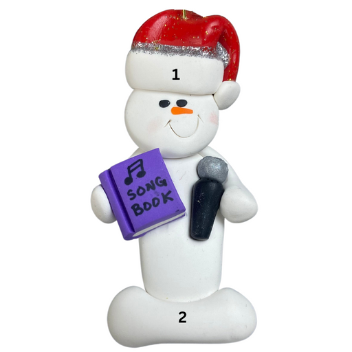 Ornament of white snowman in red hat holding a microphone and purple music book, numbered 1-2 for personalization.