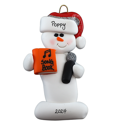Ornament of white snowman in red hat holding a microphone and orange music book, personalized with name.