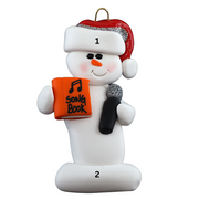 Ornament of white snowman in red hat holding a microphone and orange music book, numbered 1-2 for personalization.