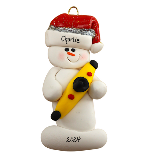 Ornament of white snowman in red hat holding a yellow kayak, personalized with name.