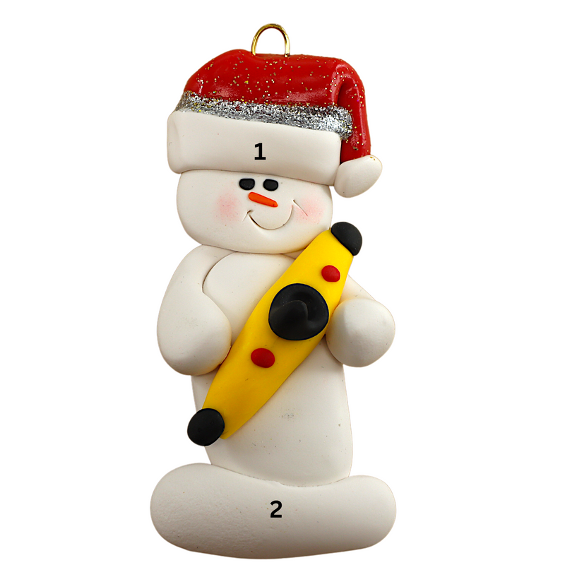 Ornament of white snowman in red hat holding a yellow kayak, numbered 1-2 for personalization.