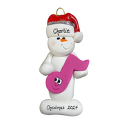 Ornament of white snowman in red hat holding a pink music note, personalized with name.