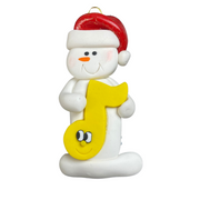 Ornament of white snowman in red hat holding a yellow music note.