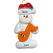 Ornament of white snowman in red hat holding an orange music note, personalized with name.