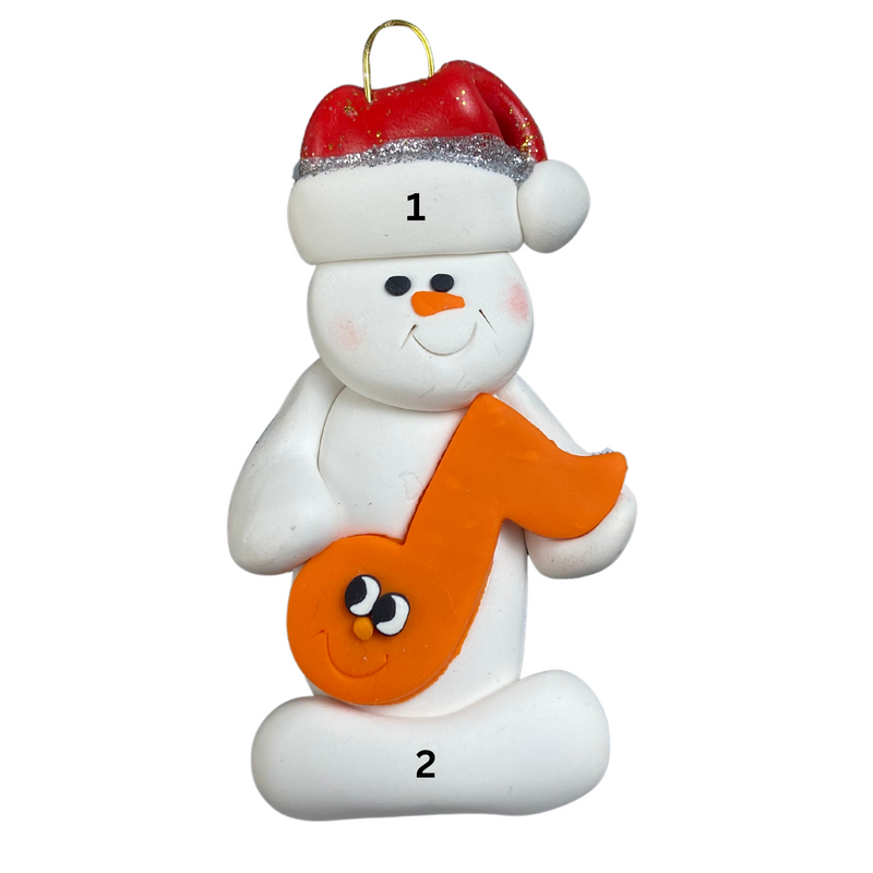Ornament of white snowman in red hat holding an orange music note, numbered 1-2 for personalization.