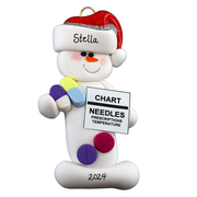 Ornament of white snowman in red hat holding various medications and a medical chart, personalized with name.