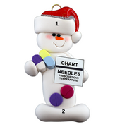 Ornament of white snowman in red hat holding various medications and a medical chart, numbered 1-2 for personalization.