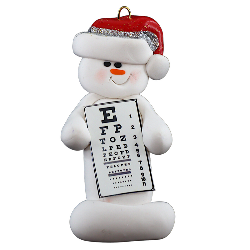 Ornament of white snowman in red hat holding an eye chart.