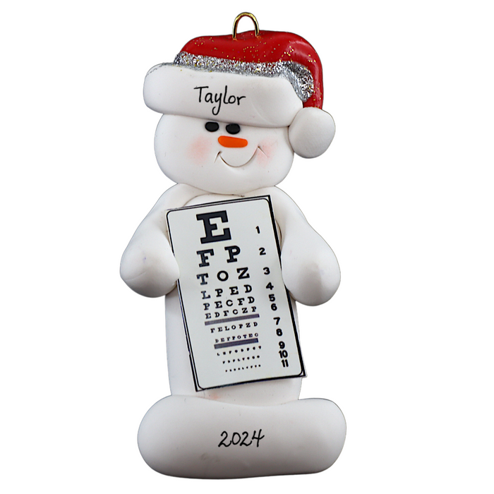 Ornament of white snowman in red hat holding an eye chart, personalized with name.