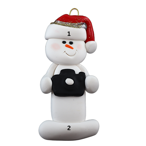 Ornament of white snowman in red hat holding a black camera, numbered 1-2 for personalization.