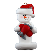 Ornament of white snowman in red hat holding a red airplane.