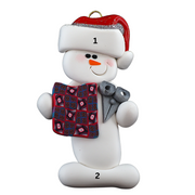 Ornament of white snowman in red hat holding a quilt block and pair of scissors, numbered 1-2 for personalization.