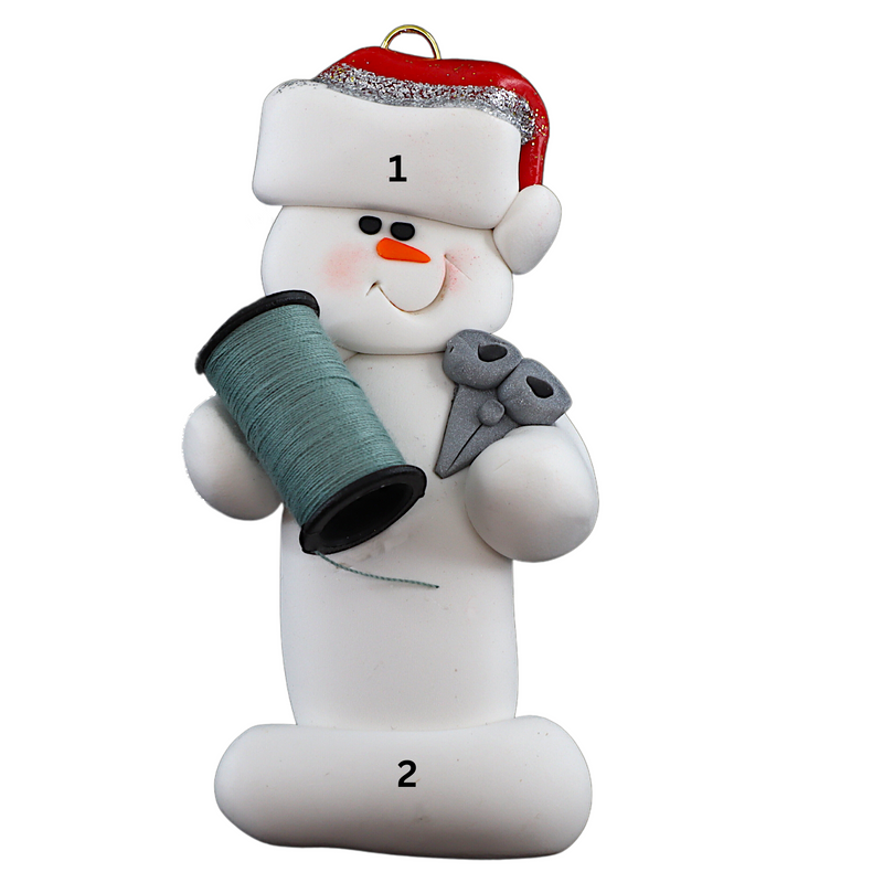 Ornament of white snowman in red hat holding a spool of thread and scissors, numbered 1-2 for personalization.